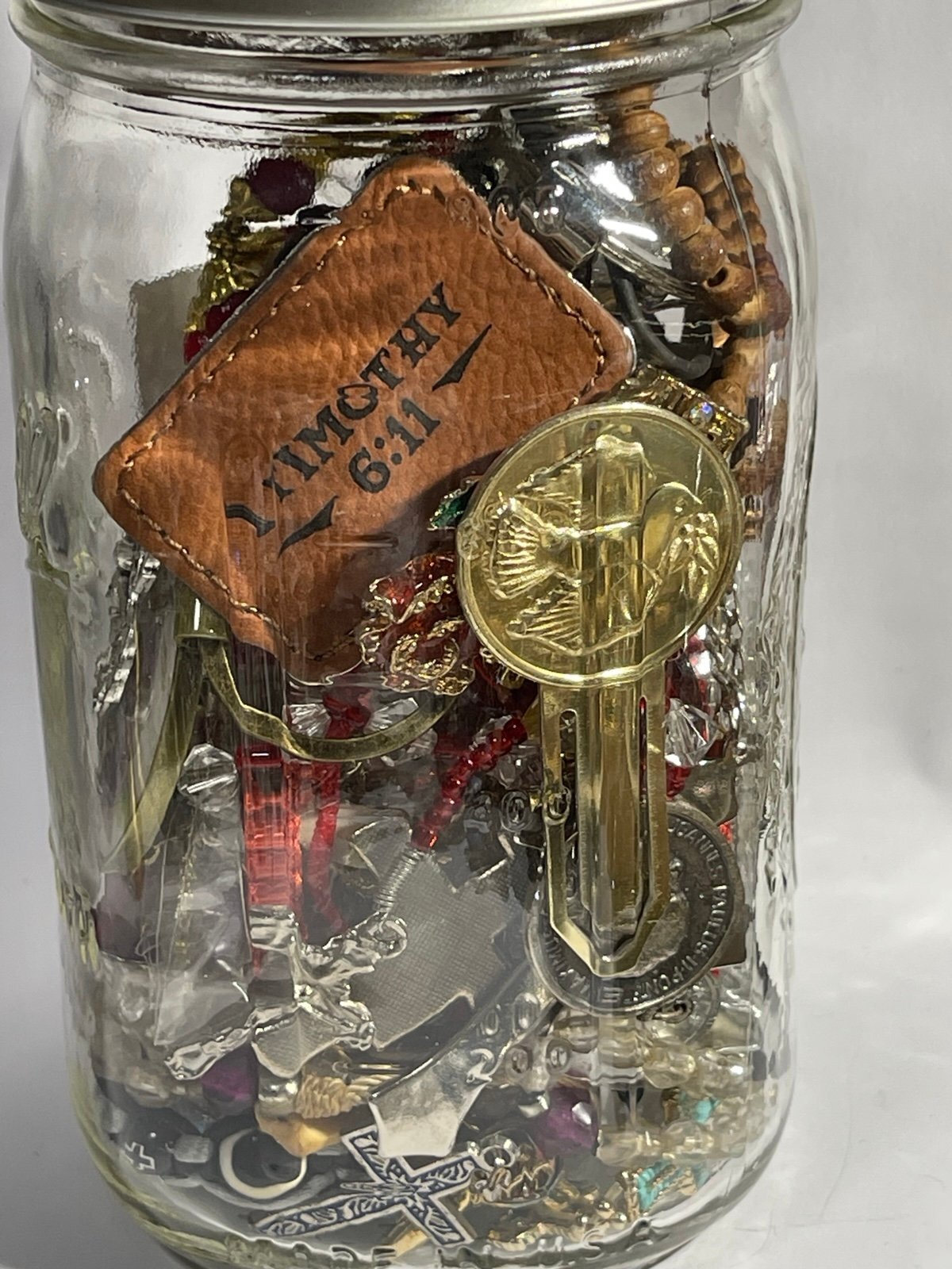 Jar of Religious Bracelets Necklaces Pendants Keychains