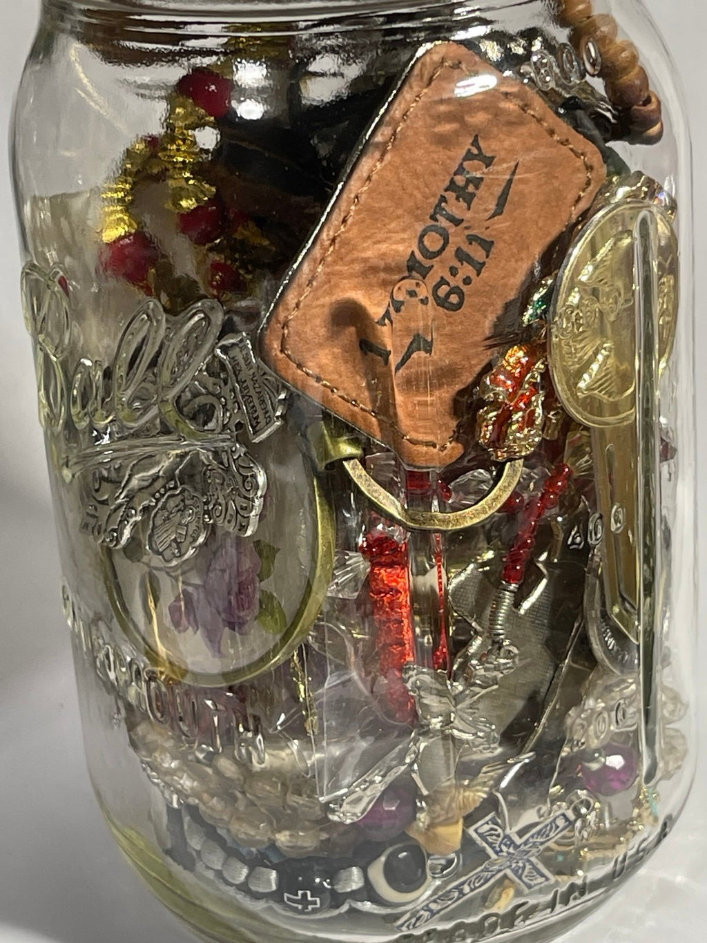 Jar of Religious Bracelets Necklaces Pendants Keychains