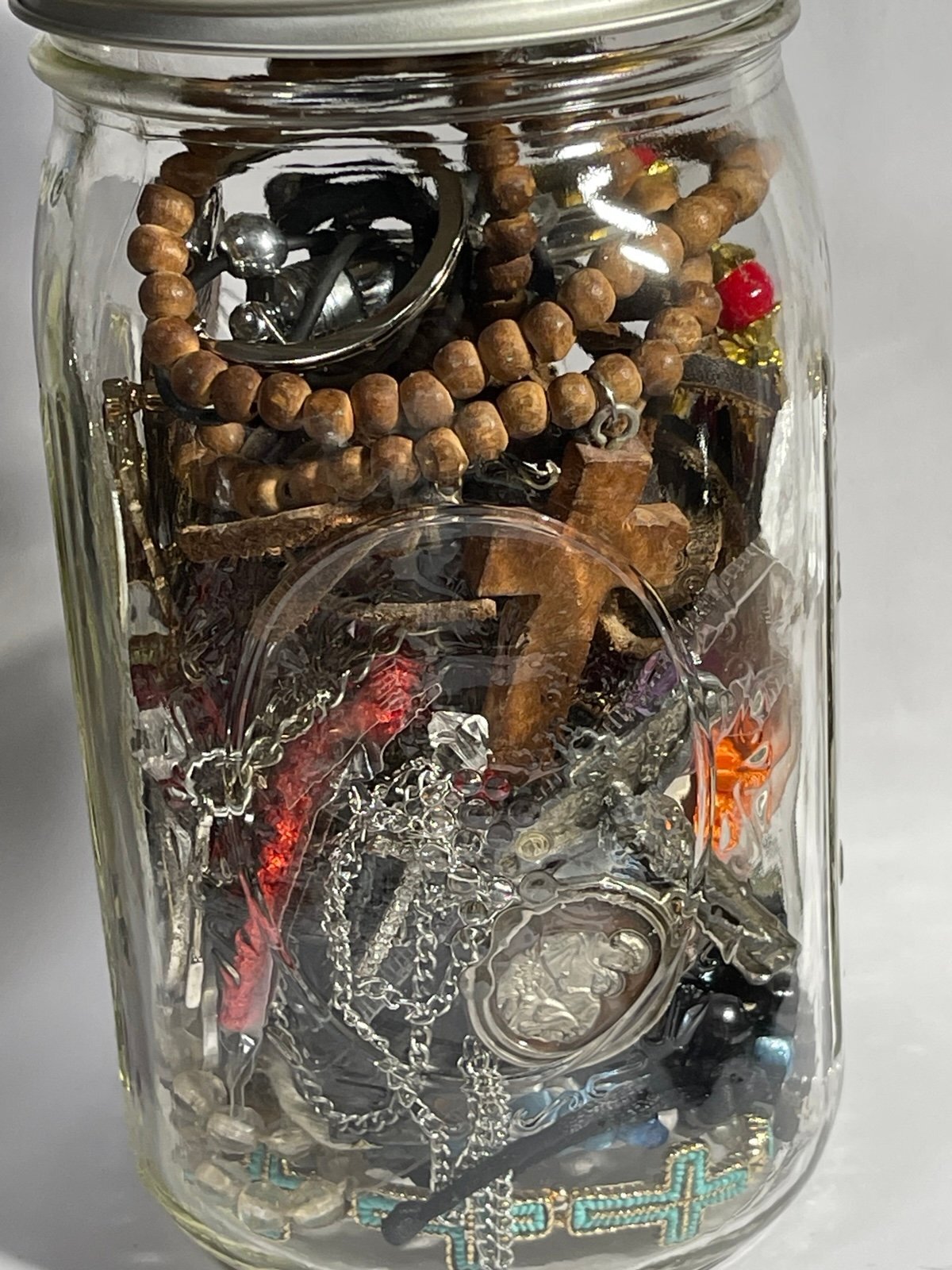 Jar of Religious Bracelets Necklaces Pendants Keychains