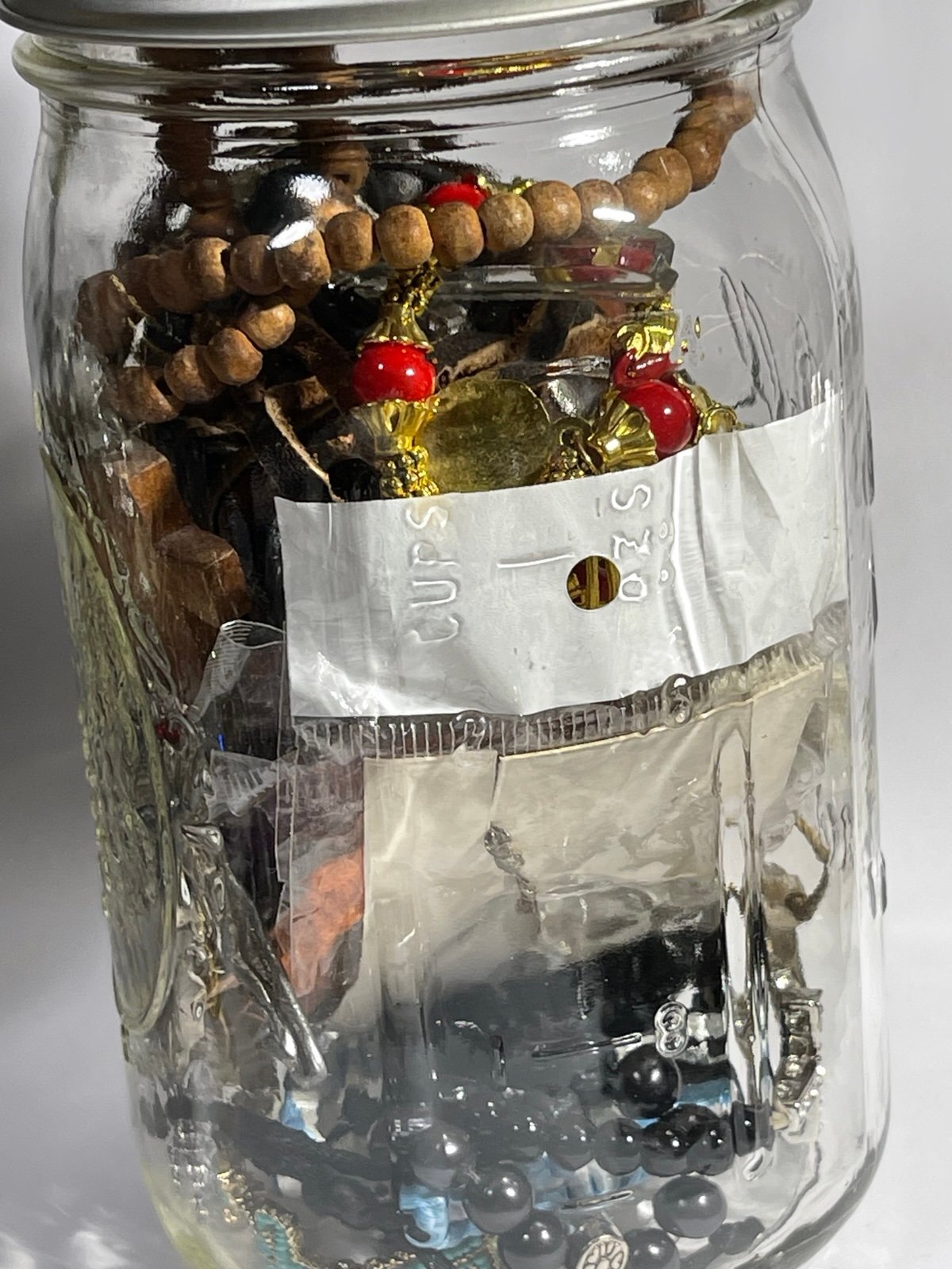 Jar of Religious Bracelets Necklaces Pendants Keychains